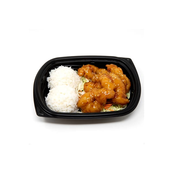 Imperial Chinese's orange chicken with white rice and shredded cabbage in a black takeout container.