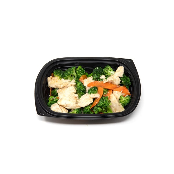 Imperial Chinese chicken and broccoli with carrots in a black takeout container.