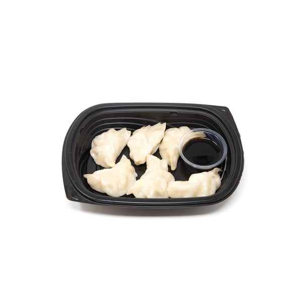 Six Imperial Chinese dumplings and a small cup of soy sauce in a black takeout container.