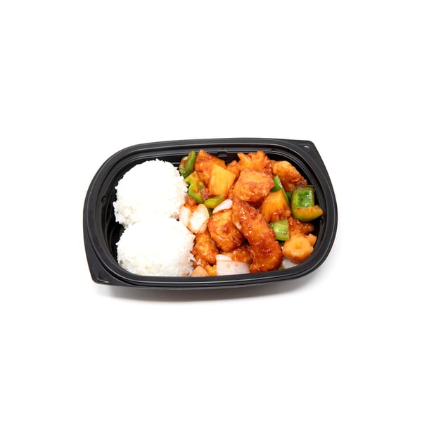 Sweet and sour chicken with pineapple, bell peppers, and onions, served with white rice in a black container.